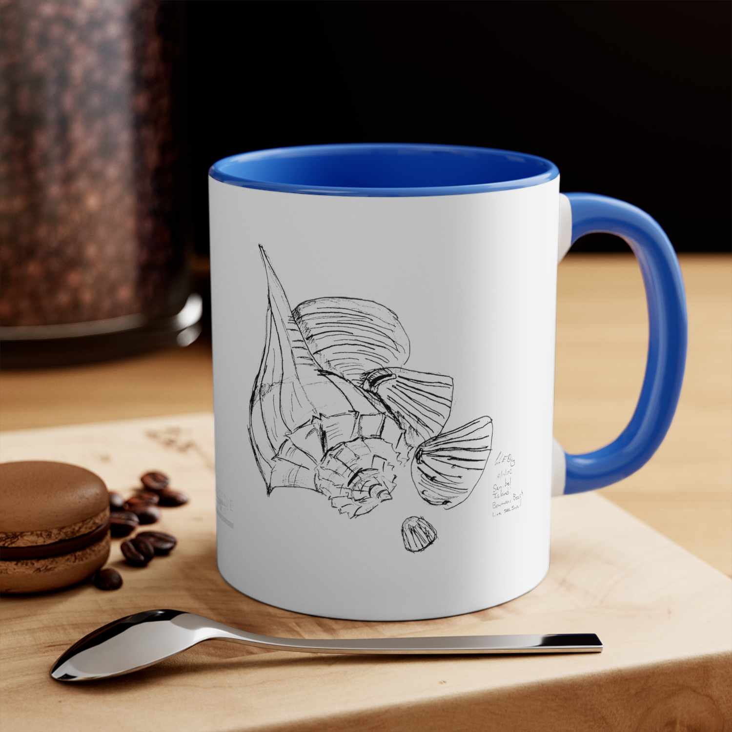 Collection Image for All Home Decor : White Coffee Mug with Black Line Art featuring a Sea Snail and several shells. Inside of mug and handle are a vivid blue.